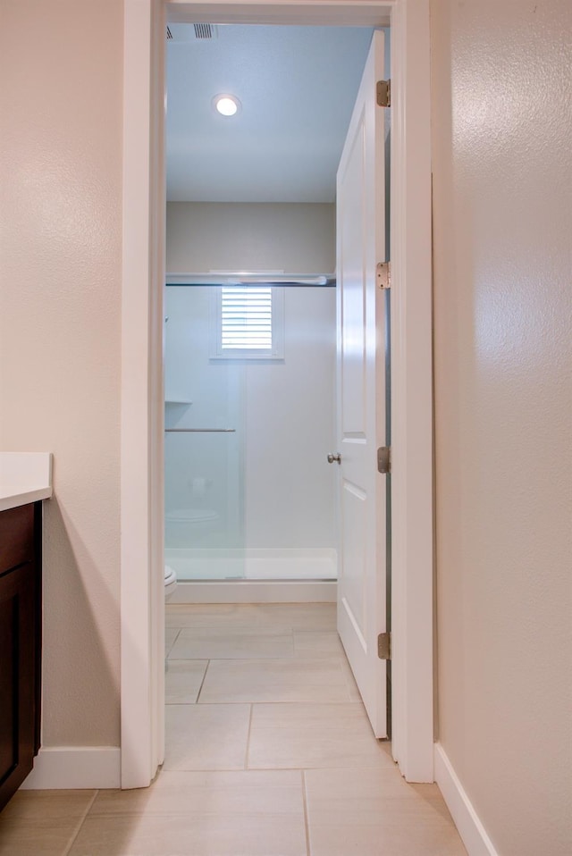 2791 E Tuolumne Rd, Turlock, CA 95382 - bathroom featuring a shower stall, vanity, toilet, baseboards, and recessed lighting