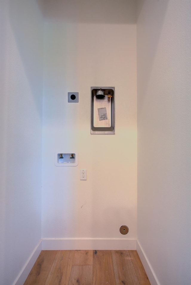 2791 E Tuolumne Rd, Turlock, CA 95382 - laundry area featuring electric dryer hookup, hookup for a washing machine, light wood-type flooring, and baseboards