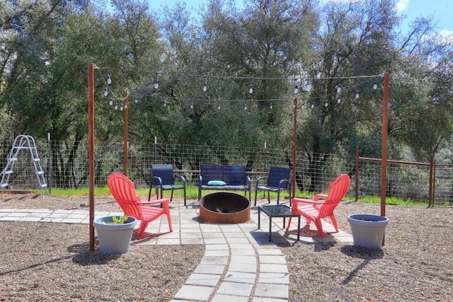 exterior space with a fire pit, fence, and a patio area
