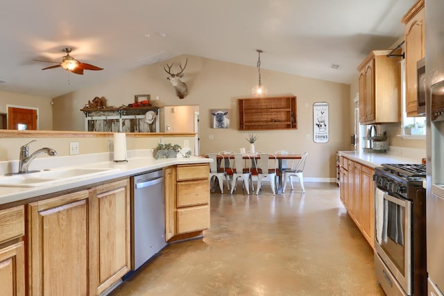 kitchen with light countertops, ceiling fan, stainless steel appliances, a sink, and vaulted ceiling