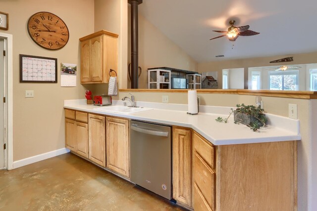 kitchen with a peninsula, ceiling fan, lofted ceiling, a sink, and stainless steel dishwasher