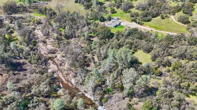 birds eye view of property with a view of trees