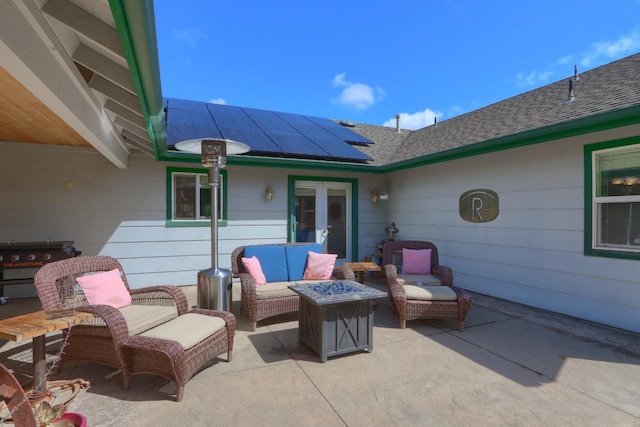 view of patio with area for grilling, french doors, and an outdoor living space with a fire pit