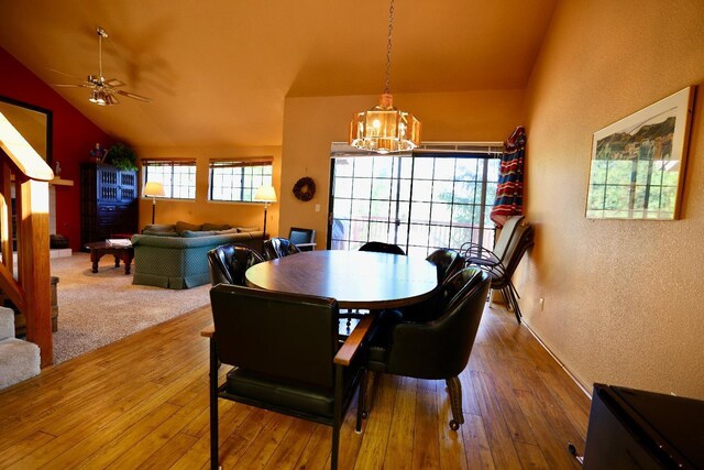 40547 Saddleback Rd, Bass Lake, CA 93604 - dining area with hardwood / wood-style floors, a textured wall, ceiling fan with notable chandelier, and lofted ceiling