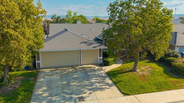 218 Casa Buena Ln, Coalinga, CA 93210 - view of front of home featuring a garage, a front lawn, roof with shingles, concrete driveway, and a mountain view
