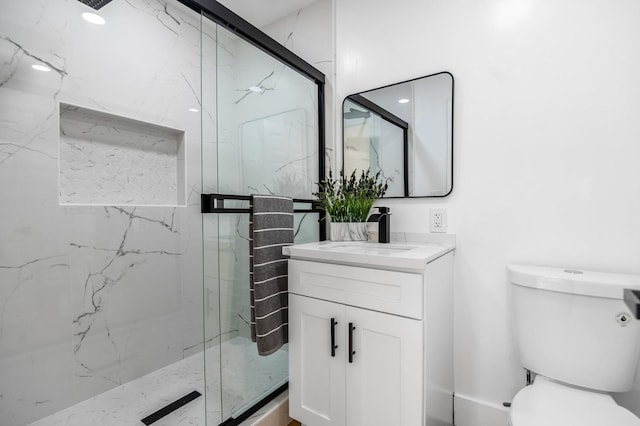 full bathroom with toilet, a marble finish shower, and vanity