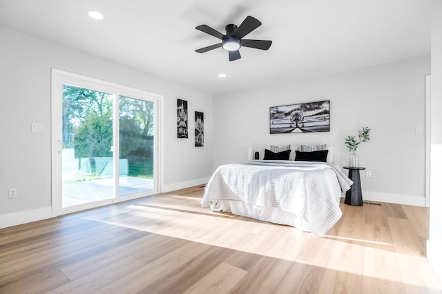 bedroom with access to exterior, wood finished floors, and baseboards