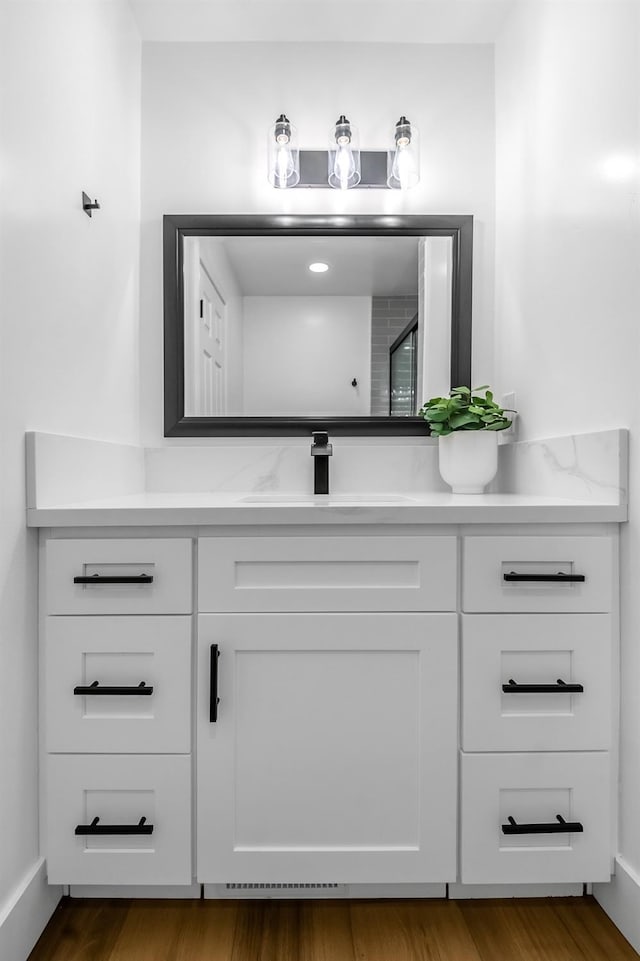 bathroom featuring vanity and wood finished floors