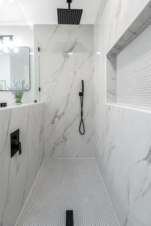 bathroom featuring a marble finish shower
