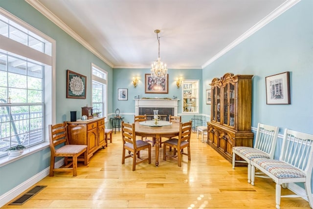 49521 Stillmeadow Dr, Oakhurst, CA 93644 - dining area with ornamental molding, visible vents, light wood-style flooring, and a chandelier