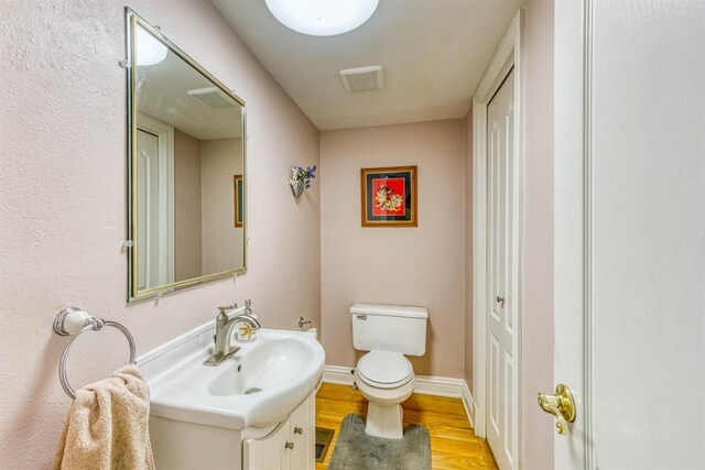 49521 Stillmeadow Dr, Oakhurst, CA 93644 - half bath with toilet, vanity, wood finished floors, and baseboards