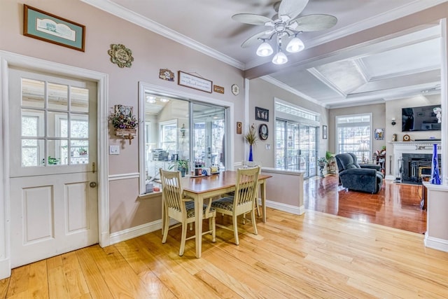 49521 Stillmeadow Dr, Oakhurst, CA 93644 - dining room with baseboards, ornamental molding, light wood-type flooring, a ceiling fan, and a glass covered fireplace