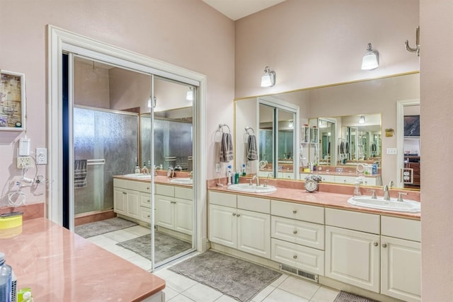 49521 Stillmeadow Dr, Oakhurst, CA 93644 - full bath with tile patterned floors, double vanity, and a sink