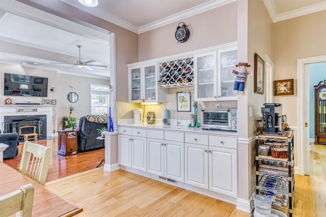 49521 Stillmeadow Dr, Oakhurst, CA 93644 - kitchen featuring light wood-style flooring, crown molding, and a toaster