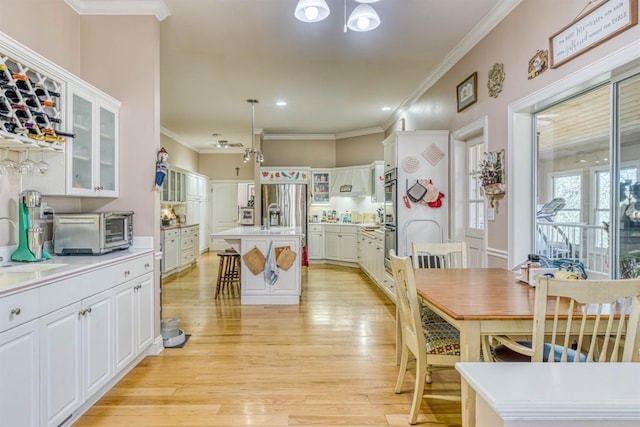 49521 Stillmeadow Dr, Oakhurst, CA 93644 - dining area featuring ornamental molding, light wood finished floors, and a toaster