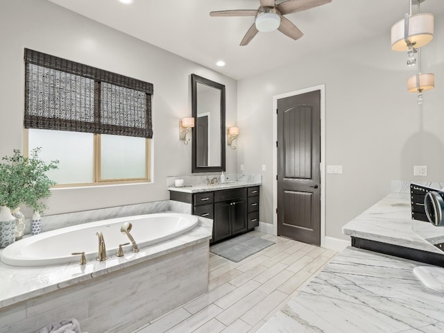 2567 E Sarazen, Fresno, CA 93730 - bathroom featuring two vanities, a ceiling fan, a garden tub, and recessed lighting