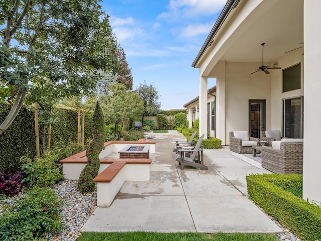 2567 E Sarazen, Fresno, CA 93730 - fenced backyard with an outdoor living space with a fire pit, a patio area, and a ceiling fan