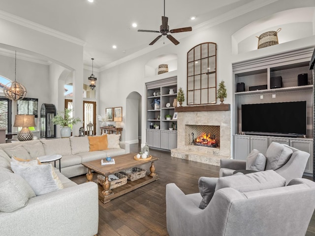 2567 E Sarazen, Fresno, CA 93730 - living area featuring arched walkways, recessed lighting, a chandelier, healthy amount of natural light, and crown molding