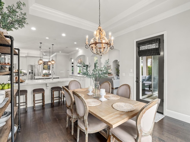 2567 E Sarazen, Fresno, CA 93730 - dining area with arched walkways, a chandelier, dark wood finished floors, crown molding, and recessed lighting