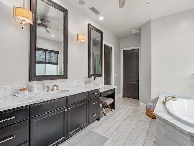 2567 E Sarazen, Fresno, CA 93730 - full bathroom featuring ceiling fan, vanity, and a garden tub