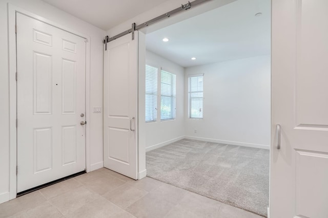 377 Wishon Way W, Madera, CA 93636 - foyer entrance with light colored carpet, a barn door, light tile patterned floors, and recessed lighting