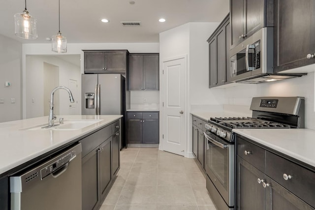 377 Wishon Way W, Madera, CA 93636 - kitchen with stainless steel appliances, light countertops, light tile patterned floors, decorative light fixtures, and recessed lighting