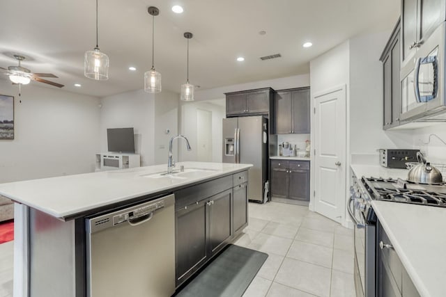377 Wishon Way W, Madera, CA 93636 - kitchen with appliances with stainless steel finishes, a ceiling fan, light countertops, recessed lighting, and an island with sink