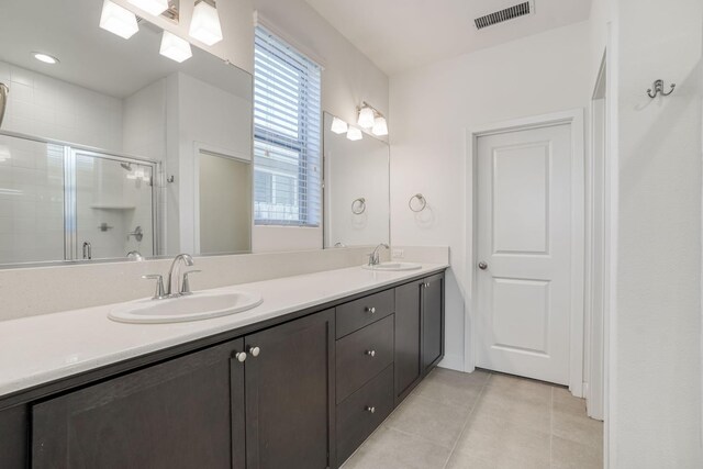 377 Wishon Way W, Madera, CA 93636 - full bath featuring tile patterned floors, double vanity, tiled shower, and plenty of natural light