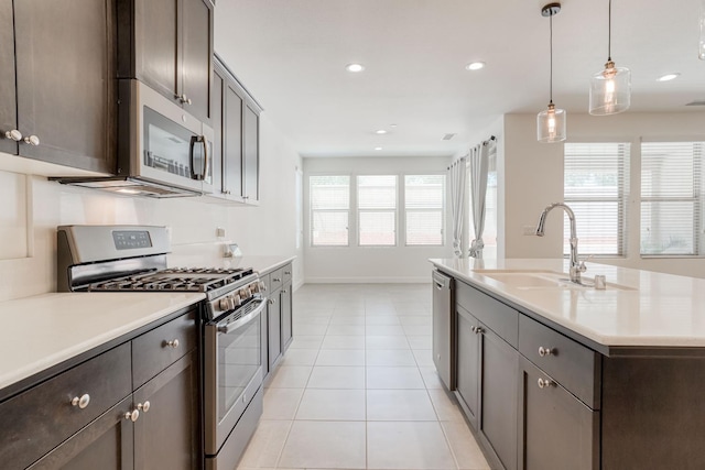 377 Wishon Way W, Madera, CA 93636 - kitchen featuring stainless steel appliances, light tile patterned floors, light countertops, recessed lighting, and dark brown cabinets