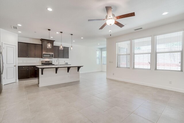 377 Wishon Way W, Madera, CA 93636 - kitchen featuring appliances with stainless steel finishes, recessed lighting, open floor plan, a breakfast bar, and ceiling fan