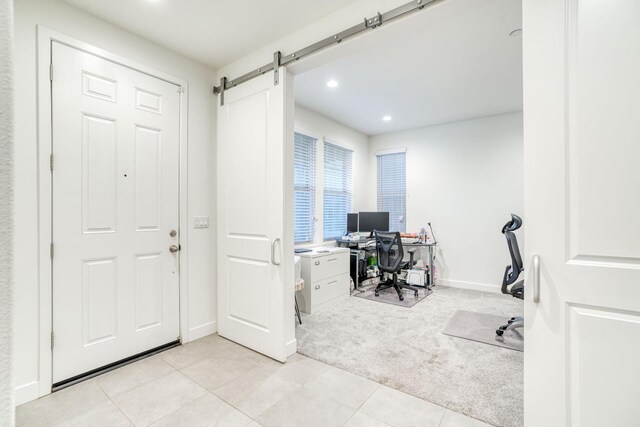 377 Wishon Way W, Madera, CA 93636 - home office with light colored carpet, recessed lighting, light tile patterned floors, and a barn door