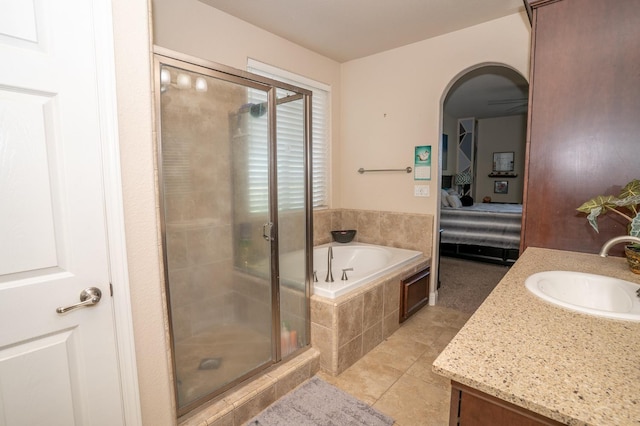 full bath with connected bathroom, tile patterned flooring, vanity, a stall shower, and a garden tub