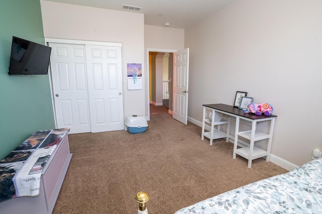 carpeted bedroom with visible vents, baseboards, and a closet