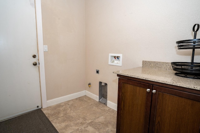 clothes washing area with cabinet space, light tile patterned floors, washer hookup, electric dryer hookup, and baseboards
