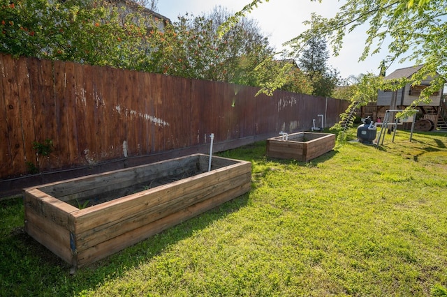 view of yard with a vegetable garden and a fenced backyard