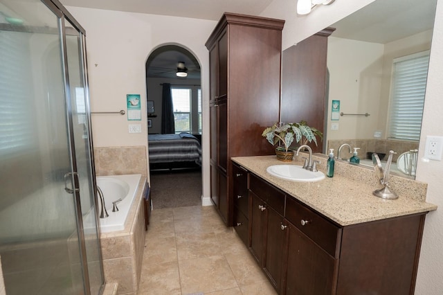 ensuite bathroom with a shower stall, vanity, a bath, tile patterned floors, and a ceiling fan