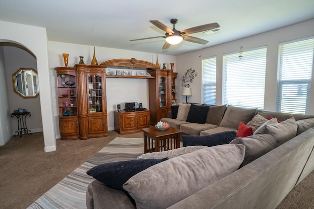 living room with carpet flooring, a ceiling fan, visible vents, and baseboards