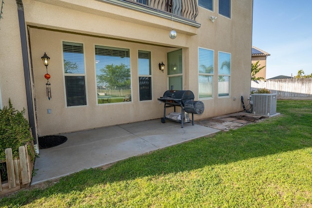 view of patio with fence, grilling area, central AC, and a balcony