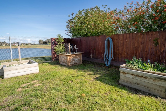 view of yard with fence and a vegetable garden
