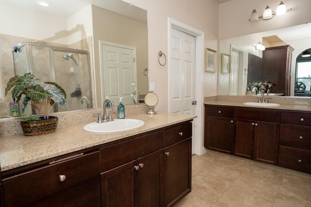 bathroom with two vanities, a shower stall, tile patterned flooring, and a sink