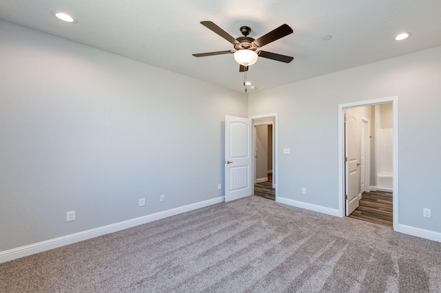 unfurnished bedroom with ensuite bathroom, baseboards, ceiling fan, recessed lighting, and carpet flooring