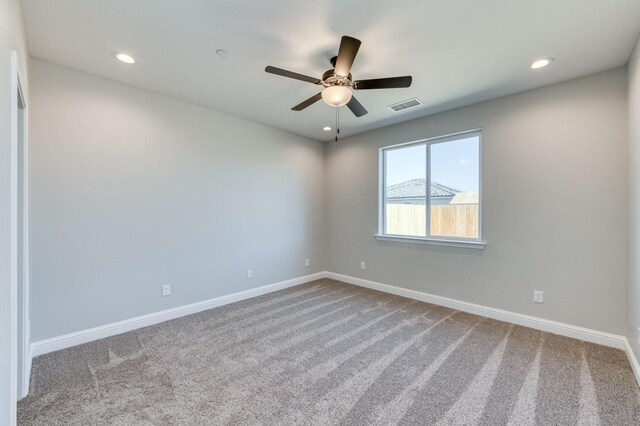 carpeted empty room with visible vents, ceiling fan, recessed lighting, and baseboards