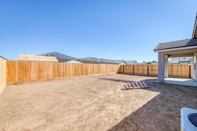 view of yard featuring a patio and a fenced backyard