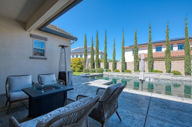 view of patio / terrace with fence and a fire pit