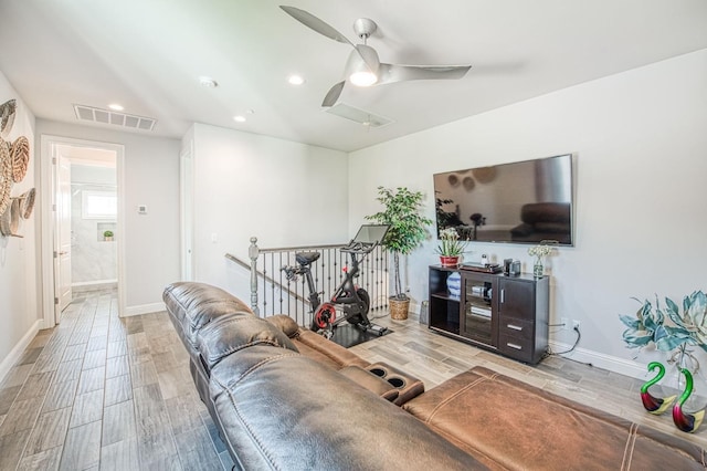 living area featuring baseboards, wood finish floors, recessed lighting, visible vents, and ceiling fan