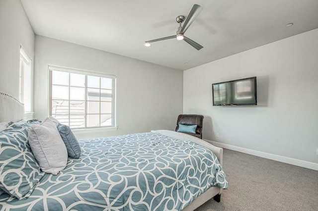 bedroom featuring multiple windows, baseboards, a ceiling fan, and carpet floors