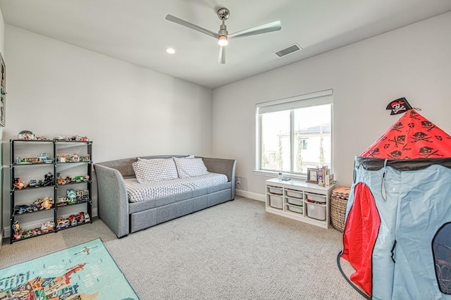 carpeted living area featuring recessed lighting, visible vents, baseboards, and ceiling fan