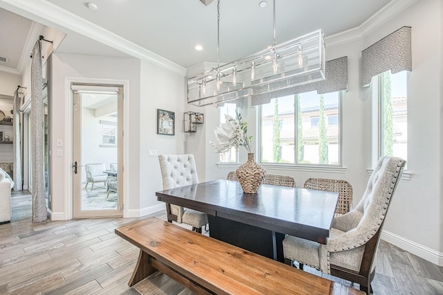 dining area with recessed lighting, light wood-style flooring, baseboards, and crown molding