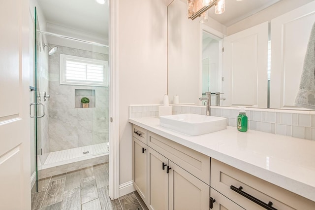 bathroom featuring tasteful backsplash, vanity, wood tiled floor, and a stall shower