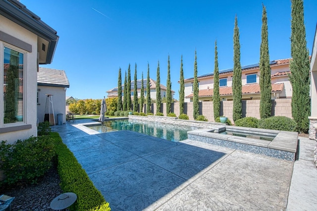 view of swimming pool featuring a patio area, fence, an in ground hot tub, and a fenced in pool